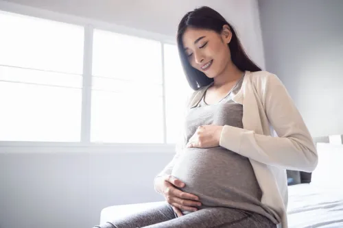 A pregnant woman enjoying the sunshine, representing the importance of vitamin D during pregnancy
